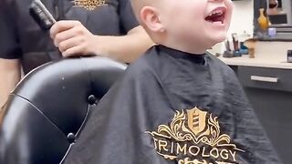 Kid laughs uncontrollably while getting a haircut