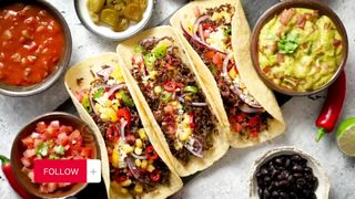 Tasty Mexican meat tacos served with various vegetables and salsa.