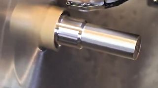 piece of iron being processed on a lathe
