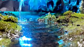 miniature waterfall with river and moss