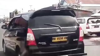 a mother riding an electric bicycle in the wrong lane