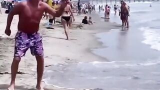 Grandpa shows tricks with a plate on the beach