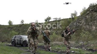 Group of Ukrainian military using a drone to detect enemy positions stock video