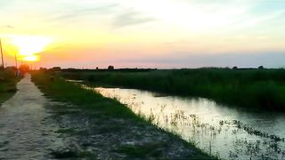 Sunset with village road