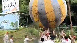 playing volleyball with a large ball