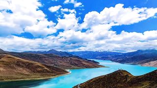 Blue sky, white clouds, mountains and flowing water