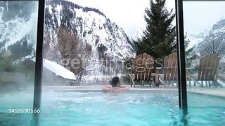 Lady inside  water pool in Alp - stock video Asian woman enjoying  water pool in the Italian Alps snowy Mont Blanc