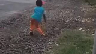 A small child dancing enjoys the horn of the Telolet bus, so the bus stops seeing the child