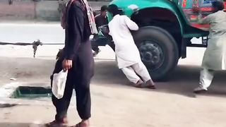 The truck is being pulled by a donkey cart