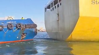 Tugboat Attaches Towing Line to Sailing Chemical