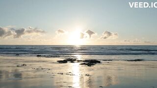 The sun rises over the ocean.
