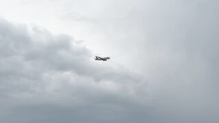 Journey Through the Cloudscape: A Majestic Airliner Soars Across the Sky