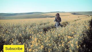 Freedom's Embrace: The Backside Journey of a Woman Amidst Fields of Blossoms