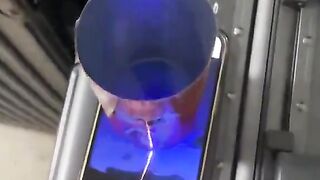 Kaleidoscope effect of a firework seen through a tin over a phone