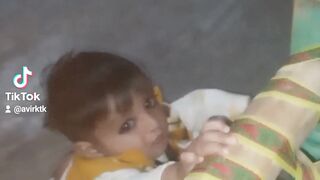 A little kid try to stand-up and his sister giving love to him