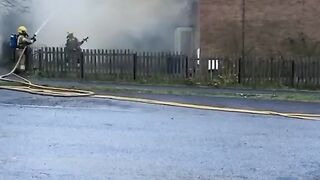 Smoke billows from a house after a lightning strike in Wiltshire