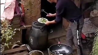 THE HEN HELPS HER O WNER COOK