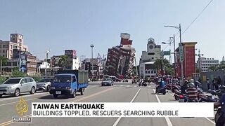 Taiwan earthquake_ Buildings toppled, rescuers searching rubble.
