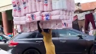 a woman carrying a lot of things