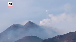 Mount Etna blows spectacular smoke rings into the sky.