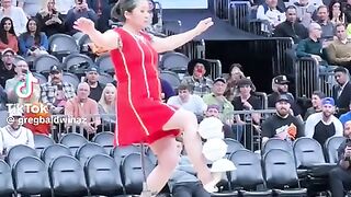 Rong Niu aka Red Panda performs her bowl balancing act during halftime at an  13  NBA game