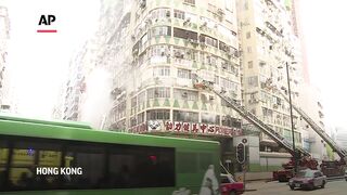 Hong Kong firefighters evacuate residents from high-rise block swept by deadly blaze.