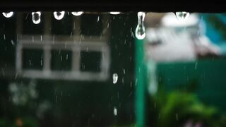 Closeup of raindrops falling from the roof - AdalineTV