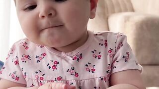 A very cute baby is learning to talk