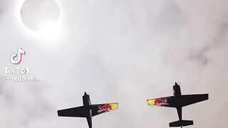 Red Bull airplanes fly under the solar eclipse for a photo