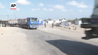 Dozens of trucks bring aid into Gaza through the Rafah crossing.