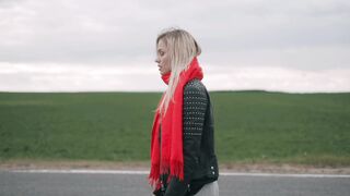 An ordinary girl is walking alone on the road.