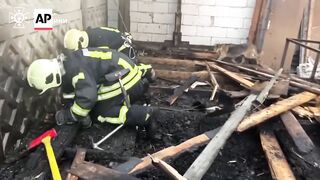 Watch Ukrainian firefighters rescue five newborn puppies after fire.