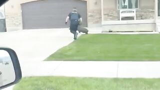 Police officer ironically chasing a wild pig.