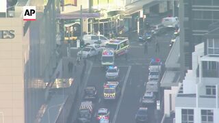 Emergency services outside Sydney shopping center after multiple people stabbed and 1 person shot.