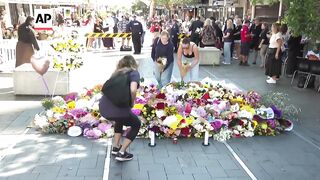 Australian PM lays flowers outside scene of Sydney stabbings.