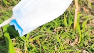 a frog relaxing on a string of masks