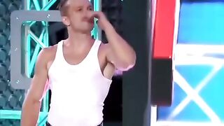 Guy shows his strength and agility to pass obstacles on ninja warrior