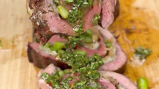 Stuffed flank steak topped with chimichurri sauce