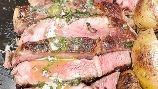 Heart shaped grilled ribeye steak and potatoes