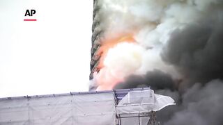 Spire tumbles, famous painting rescued at burning building in Copenhagen.