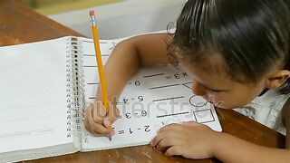 Girl doing homework طفلة تذاكر