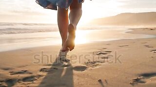 Slow motion woman feet walking barefoot by beach at golden sunset leaving footprints in sand❤.