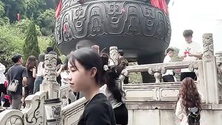 The girl threw the wishing ball into the tripod