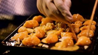 Preparing Takoyaki in a restaurant - adalinetv
