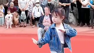 The little girl danced in the square, and the more she watched it, the more she liked it