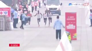 Three afican athletes letting a Chinese runner win on purpose