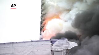 Spire tumbles, famous painting rescued at burning building in Copenhagen.