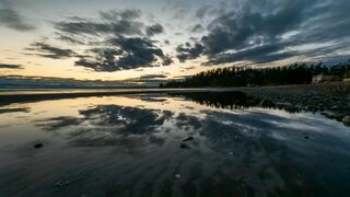 "Dawn's Embrace: Sunrise Splendor from the Shoreline"