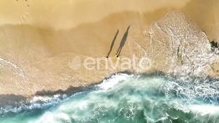 Children playing under water waves