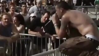 Chester Bennington hops off stage to sing to and with a fan during a Linkin Park concert